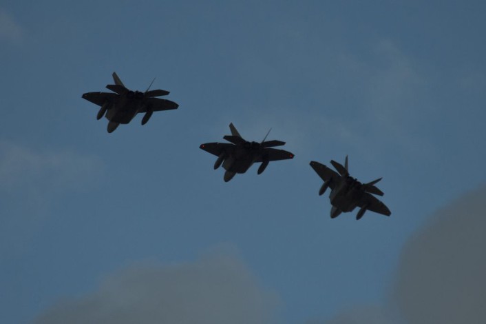 Three F-22 Raptor fighter aircraft assigned to the 95th Fighter Squadron at Tyndall Air Force Base, Fla., fly over the runway before landing at Spangdahlem Air Base, Germany, Aug. 28, 2015. The U.S. Air Force deployed four F-22s, one C-17 Globemaster III and more than 50 Airmen to Spangdahlem in support of the first F-22 European training deployment. The inaugural F-22 training deployment to Europe is funded by the European Reassurance Initiative, a $1 billion pledge announced by President Obama in March 2014. (U.S. Air Force photo by Airman 1st Class Luke Kitterman/Released)