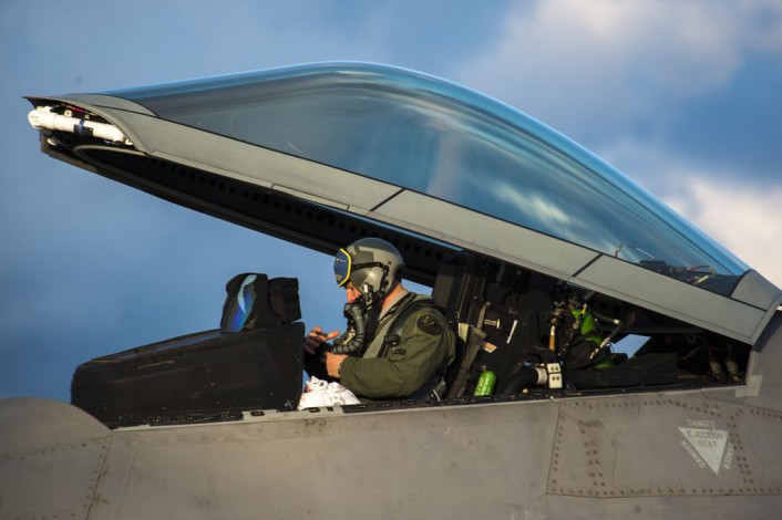 An F-22 Raptor fighter aircraft pilot assigned to the 95th Fighter Squadron at Tyndall Air Force Base, Fla., prepares to exit an F-22 at Spangdahlem Air Base, Germany, Aug. 28, 2015. The U.S. Air Force deployed four F-22 Raptors, one C-17 Globemaster III and more than 50 Airmen to Spangdahlem in support of the first F-22 European training deployment. The inaugural F-22 training deployment to Europe is funded by the European Reassurance Initiative, a $1 billion pledge announced by President Barack Obama in March 2014. (U.S. Air Force photo by Airman 1st Class Luke Kitterman/Released)