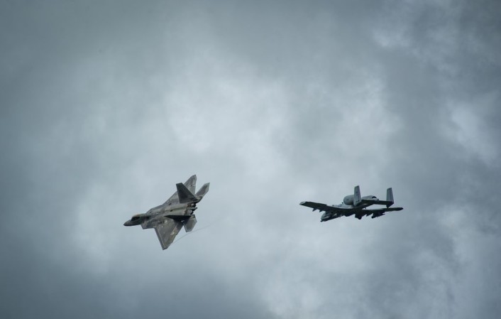An F-22 Raptor and an A-10 Thunderbolt II fly overhead before landing at Ämari Air Base, Estonia, Sept. 4, 2015, as part of a brief forward deployment. The F-22s have previously deployed to both the Pacific and Southwest Asia for Airmen to train in a realistic environment while testing partner nations' ability to host advanced aircraft like the F-22. The F-22s are deployed from the 95th Fighter Squadron at Tyndall Air Force Base, Florida. The U.S. Air Force routinely deploys aircraft and Airmen to Europe for training and exercises. (U.S. Air Force photo/ Tech. Sgt. Ryan Crane)