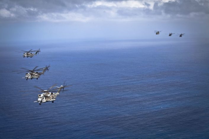 U.S. Marine CH-53E Super Stallion helicopters, left, assigned to Marine Heavy Helicopter Squadron 463, fly in formation with U.S. Army helicopters during interoperability operations off the coast of Oahu, Hawaii, April 29, 2016. HMH-463 conducted interoperability operations with the 25th Infantry Division's 25th Combat Aviation Brigade.  (U.S. Marine Corps photo by Cpl. Aaron S. Patterson)