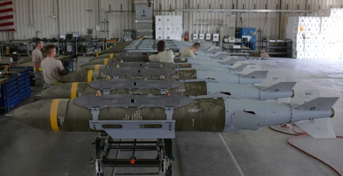 A dozen 2,000-pound joint direct attack munitions sit inside a warehouse at Al Udeid Air Base, Qatar, Dec. 17. The bombs were built by hand by airmen from the 379th Expeditionary Maintenance Squadron’s Munitions Flight. The Munitions Flight has built nearly 4,000 bombs since July 2015. (U.S. Air Force photo by Tech. Sgt. James Hodgman/Released)