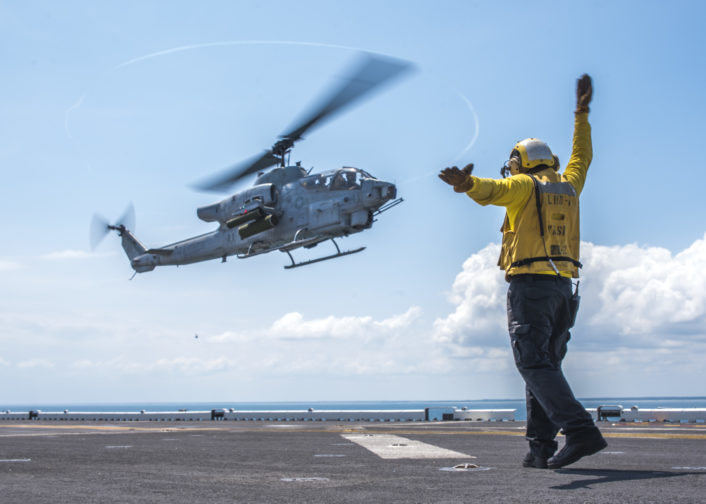 160626-N-JW440-229 ATLANTIC OCEAN (June 26, 2016) Aviation Boatswain's Mate (Handling) 3rd Class Markgerald Zagala signals an AH-1W Super Cobra to land aboard the amphibious assault ship USS Wasp (LHD 1). Wasp is deployed with the Wasp Amphibious Ready Group to support maritime security and theater security cooperation efforts in the U.S. 5th and 6th Fleet areas of operation. (U.S. Navy photo by Mass Communication Specialist 3rd Class Rawad Madanat/Released)