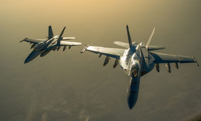 Two U.S. Navy F/A-18 Super Hornet fly in formation after receiving fuel from a KC-135 Stratotanker over Iraq in support of Operation Inherent Resolve Oct 17, 2016. The KC-135 provides the core aerial refueling capability for the U.S. Air Force and has excelled in this role for more than 50 years. (U.S. Air Force photo by Staff Sgt. Douglas Ellis/Released)