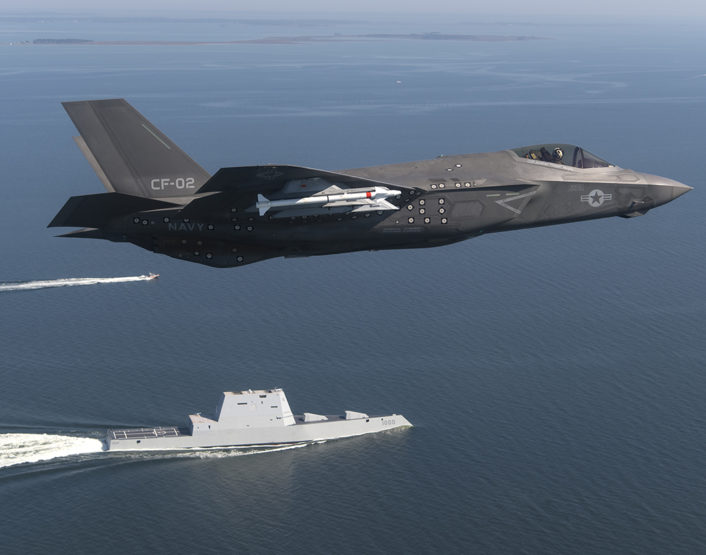An F-35 Lightning II Carrier Variant (CV) piloted by U.S. Marine Corps Maj. Robert "Champ" Guyette II, a test pilot from the F-35 Pax River Integrated Test Force (ITF) assigned to the Salty Dogs of Air Test and Evaluation Squadron (VX) 23, flies over the stealth guided-missile destroyer USS Zumwalt (DDG 1000) as the ship transits the Chesapeake Bay on Oct. 17, 2016. USS Zumwalt, the Navy's newest and most technologically advanced surface ship, joined the fleet Oct. 15. The F-35C Lightning II — a next generation single-seat, single-engine strike fighter that incorporates stealth technologies, defensive avionics, internal and external weapons, and a revolutionary sensor fusion capability — is designed as the U.S. Navy’s first-day-of-war, survivable strike fighter. The U.S. Navy anticipates declaring the F-35C combat-ready in 2018. (U.S. Navy photo by Andy Wolfe/Released)