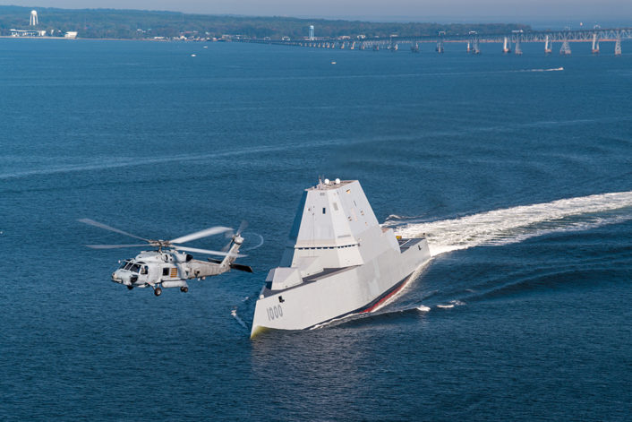 161017-N-CE233-334 CHESAPEAKE BAY, Md. (Oct. 17, 2016) An SH-60R assigned to Air Test and Evaluation Squadron (HX) 21 flies near USS Zumwalt (DDG 1000) as the ship travels to its new home port of San Diego, California. Zumwalt was commissioned in Baltimore, Maryland, Oct. 15 and is the first in a three-ship class of the Navy's newest, most technologically advanced multi-mission guided-missile destroyers. (U.S. Navy photo by Liz Wolter/Released)