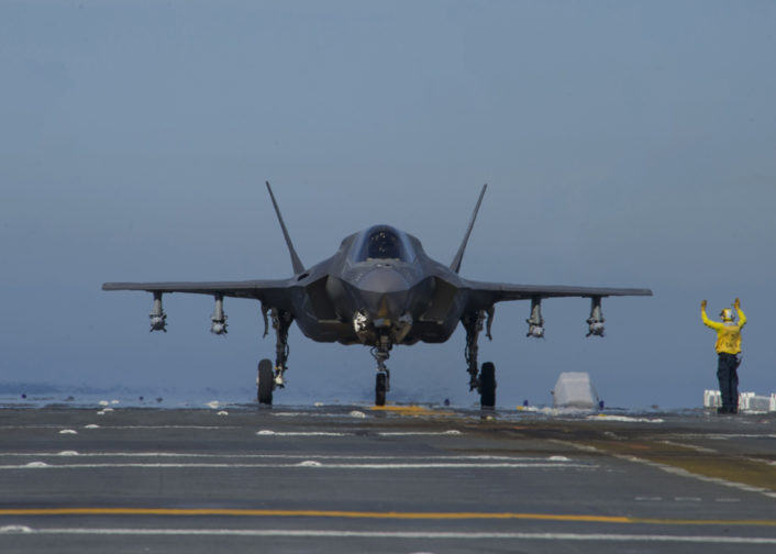 161104-N-VR008-0030 PACIFIC OCEAN (Nov. 4, 2016) A Sailor directs F-35B Lightning II aircraft on the flight deck of amphibious assault ship USS America (LHA 6) during flight operations. The F-35B short takeoff/vertical landing (STOVL) variant is the world’s first supersonic STOVL stealth aircraft. America, with Marine Operational Test and Evaluation Squadron 1 (VMX-1), Marine Fighter Attack Squadron 211 (VMFA-211) and Air Test and Evaluation Squadron 23 (VX-23) embarked, are underway conducting operational testing and the third phase of developmental testing for the F-35B Lightning II aircraft, respectively. The tests will evaluate the full spectrum of joint strike fighter measures of suitability and effectiveness in an at-sea environment. (U.S. Navy photo by Petty Officer 3rd Class Kyle Goldberg/Released)