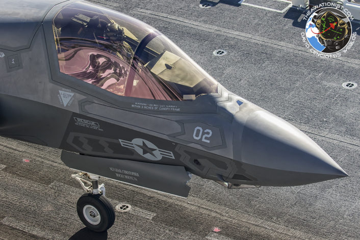 F-35B from VMFA-211 taxis to take off postion on the deck of the USS America (LHA-16 during proof of concept demonstration November19. The American Flag graphic on the America's "Conning Tower" is reflected in the F-35Bs canopy.